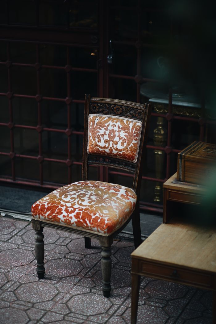 Vintage upholstered chair with floral pattern in an Istanbul patio setting.